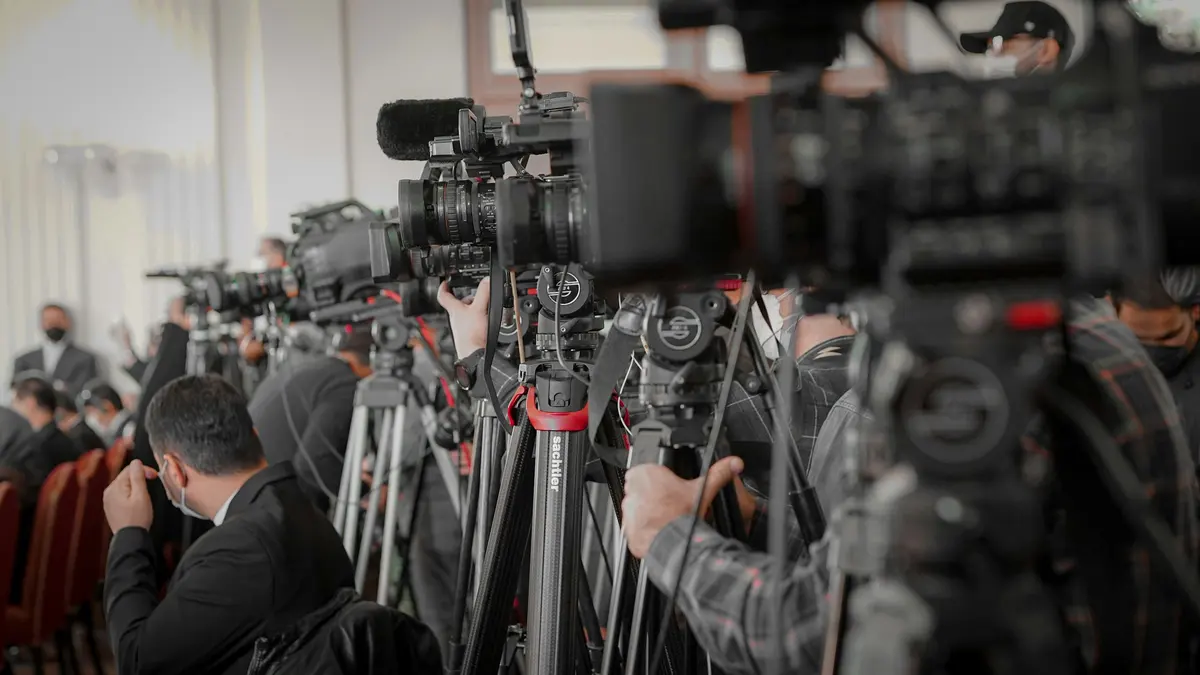 Cameras lined up at a press event