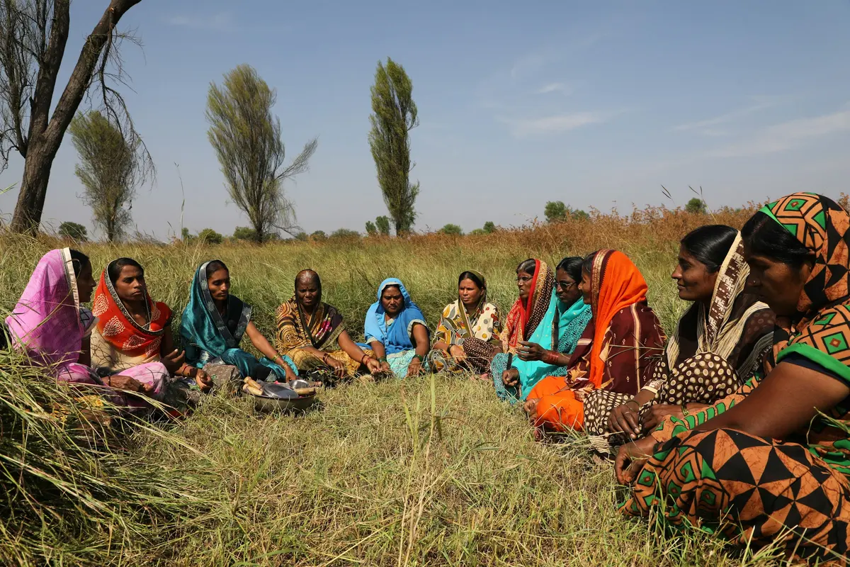 A women's group, meeting in the field