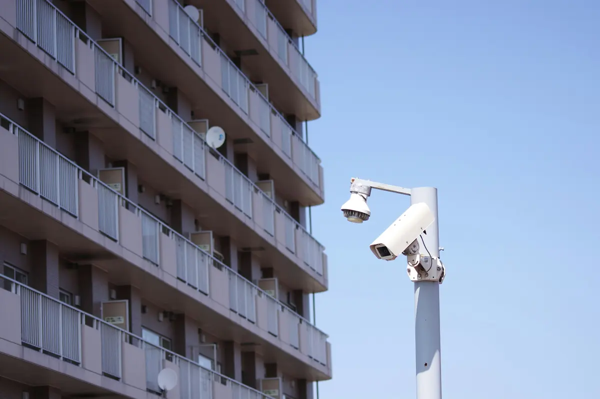 An apartment block and its security camera