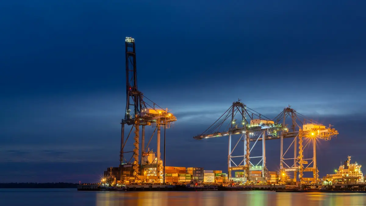 Container cranes at a port, after dark