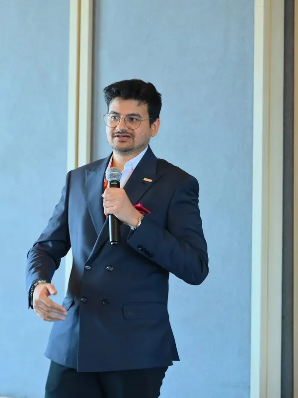 Eashan Gupta, founder of Agentec, speaking with a microphone in Bengaluru